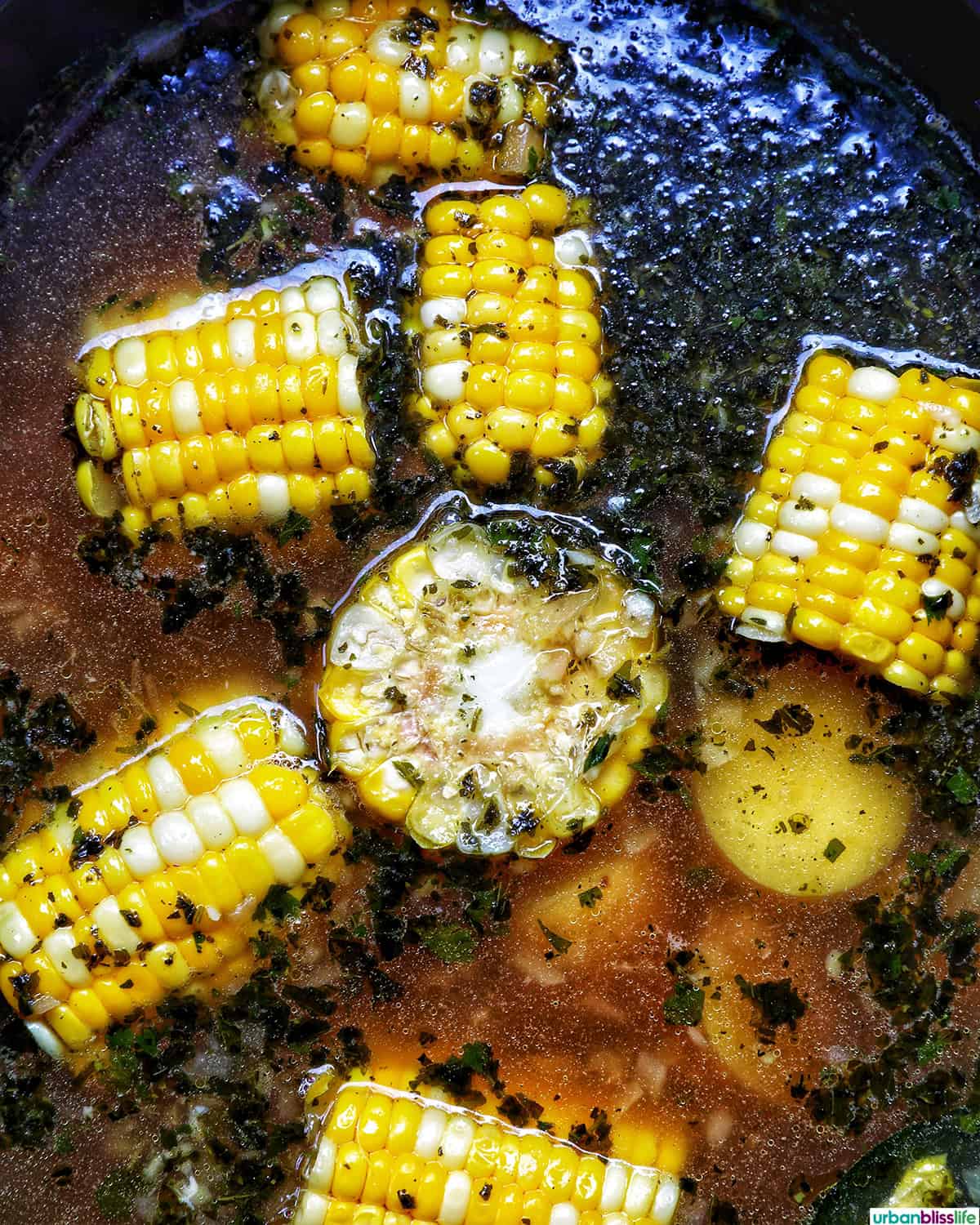 Colombian Ajiaco soup cooking in a Dutch oven.