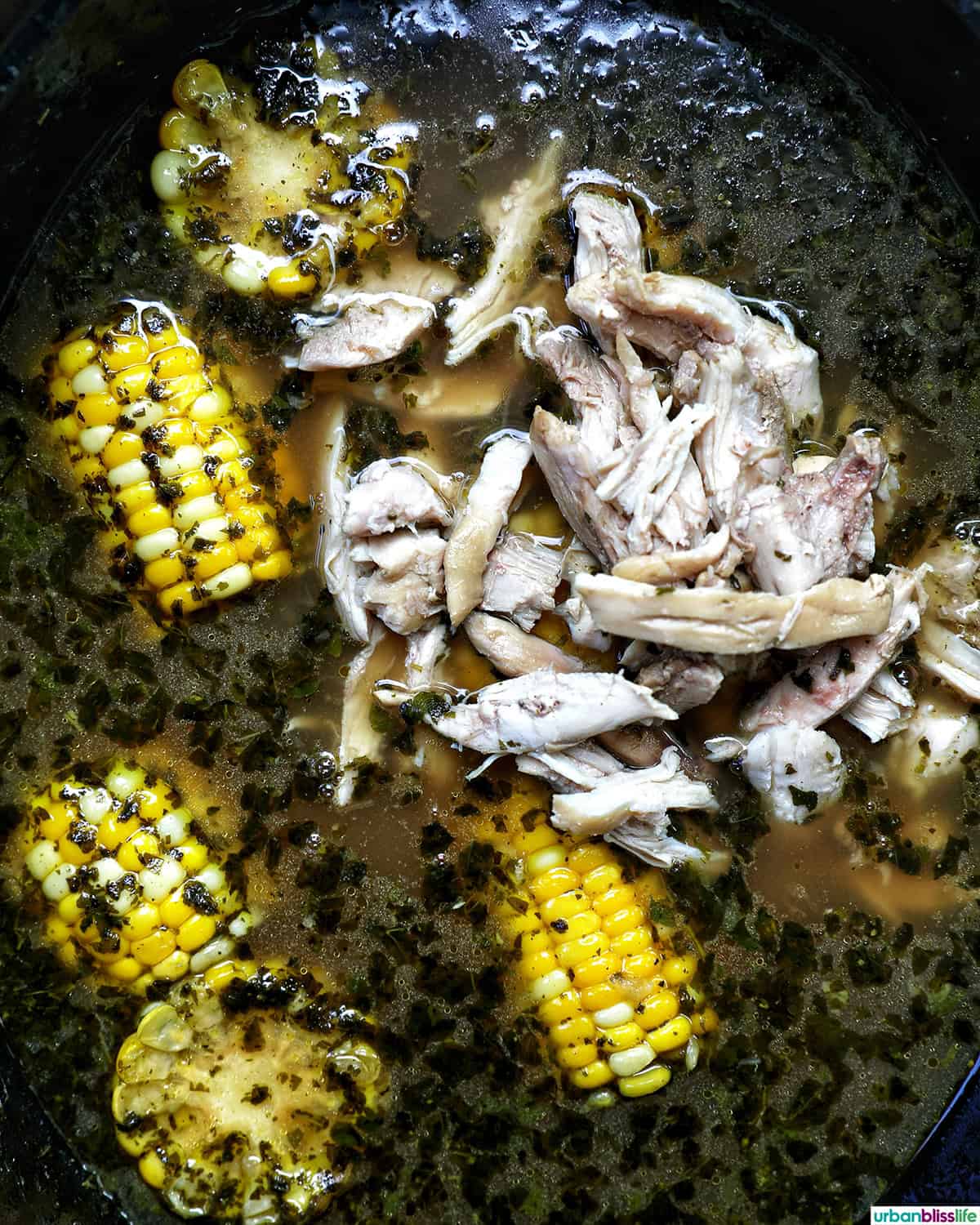Colombian Ajiaco soup cooking in a Dutch oven.
