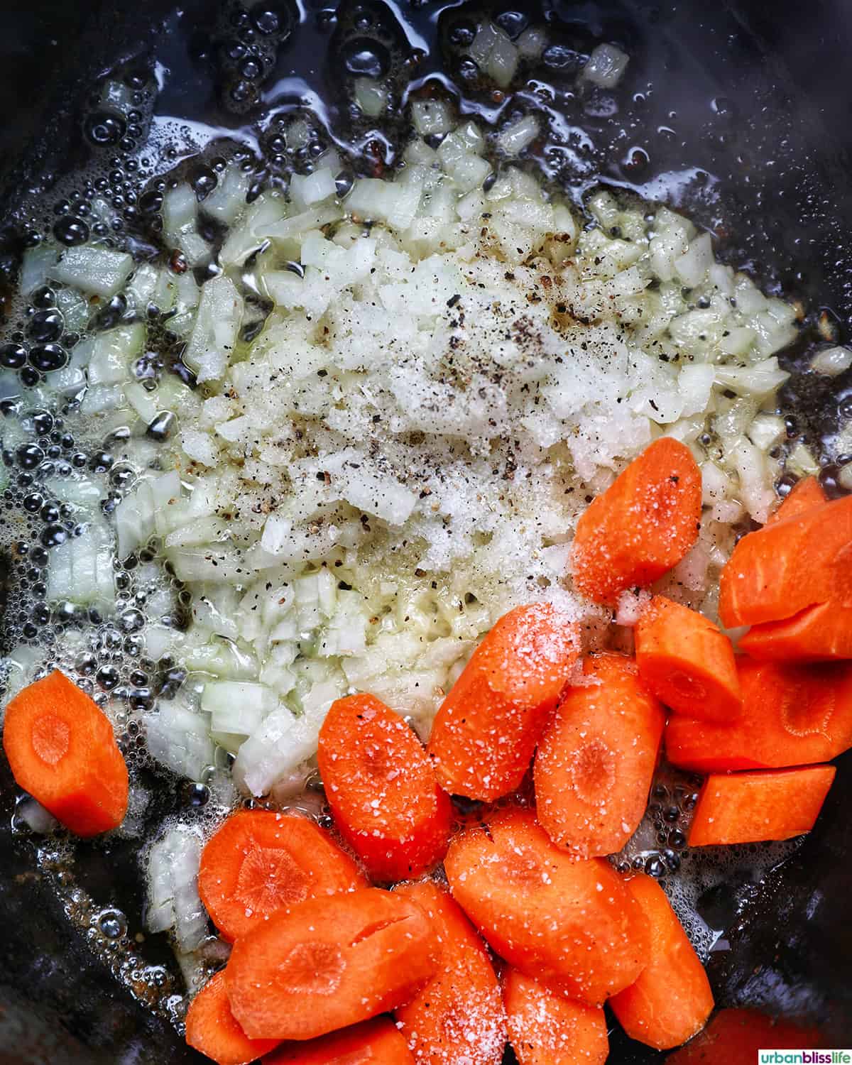 vegetables in a dutch oven cooking to make coq au vin.