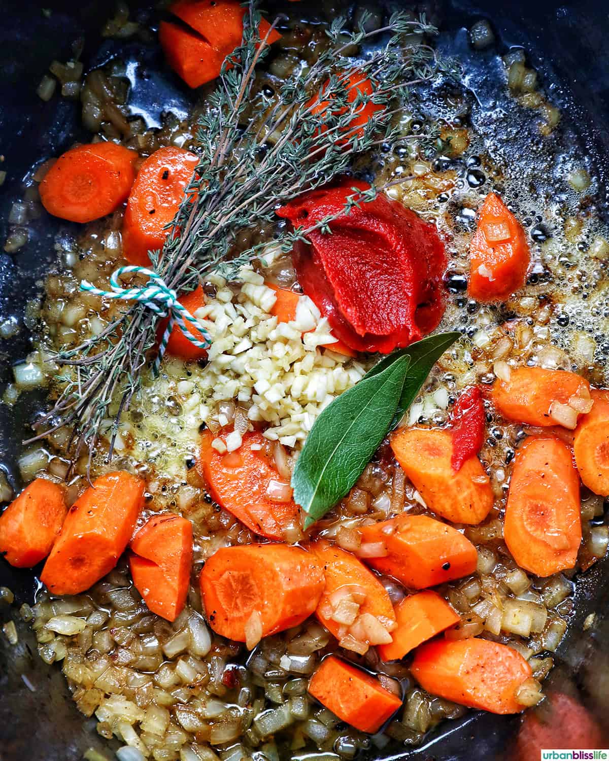 vegetables in a dutch oven cooking to make coq au vin.