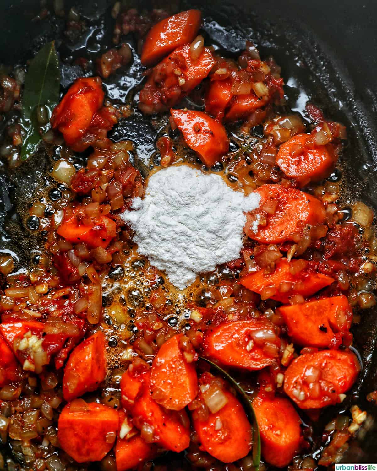 vegetables in a dutch oven cooking to make coq au vin.