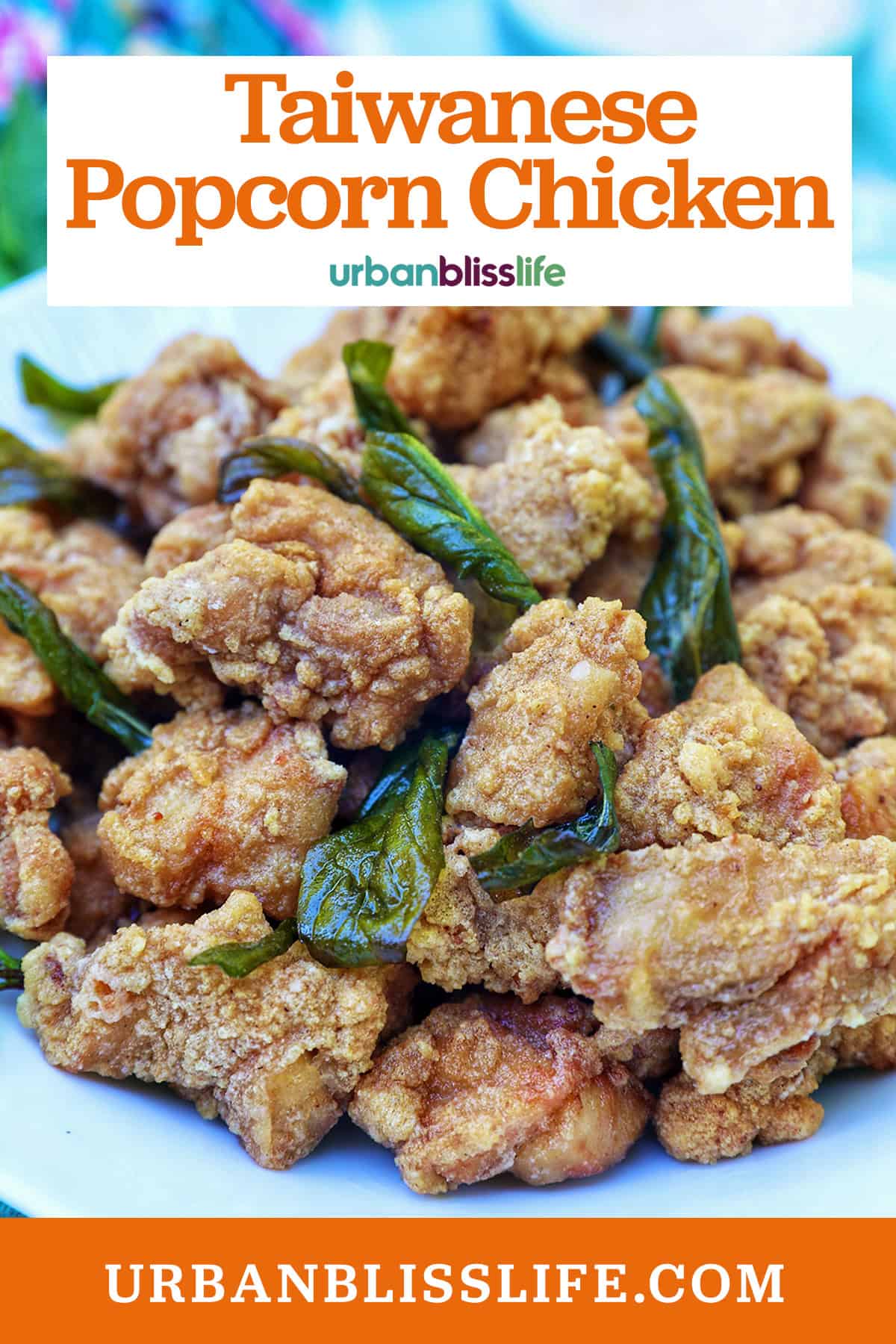 bowl of Taiwanese popcorn chicken with fried basil and title text overlay.