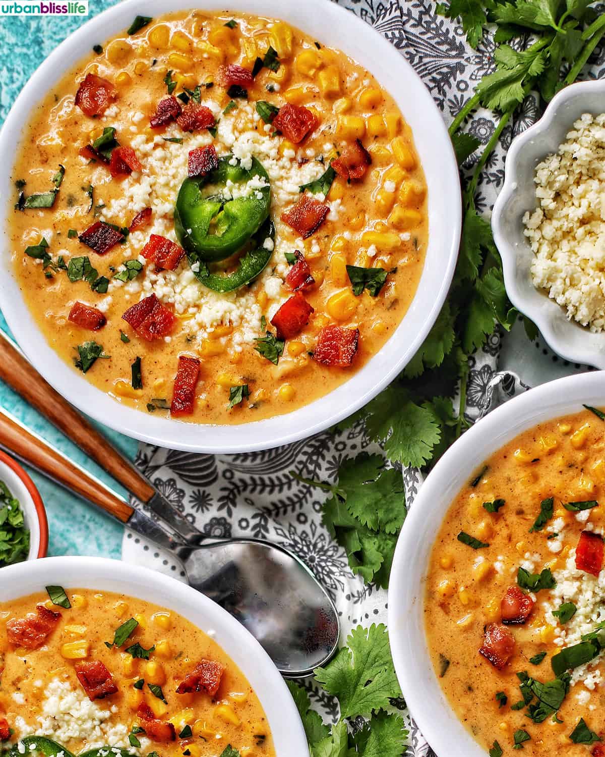 bowls of Instant Pot Mexican Street Corn Chowder with bacon, jalapenos, and Cotija cheese.
