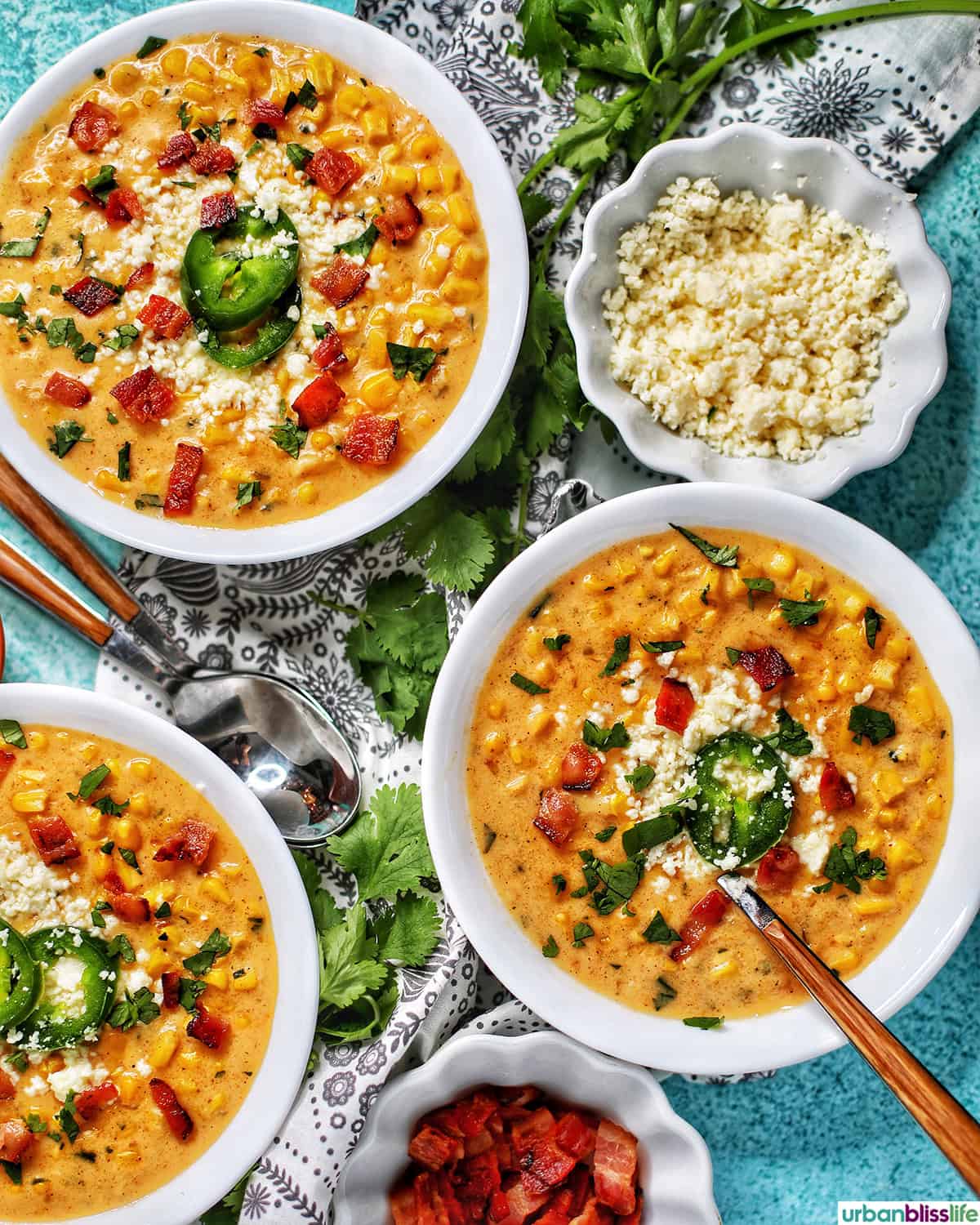 bowls of Instant Pot Mexican Street Corn Chowder with bacon, jalapenos, and Cotija cheese.