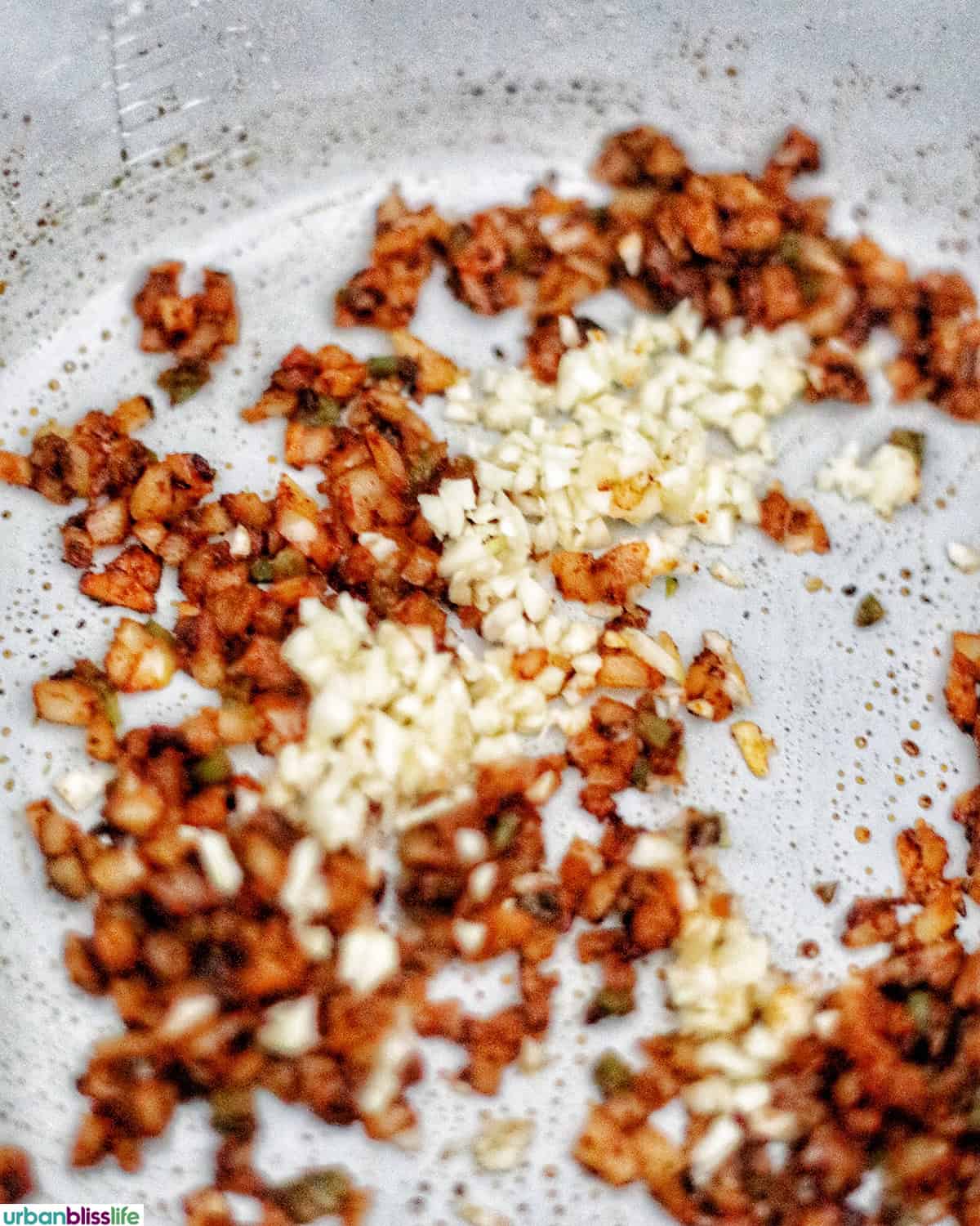 bacon and garlic cooking in an Instant Pot.