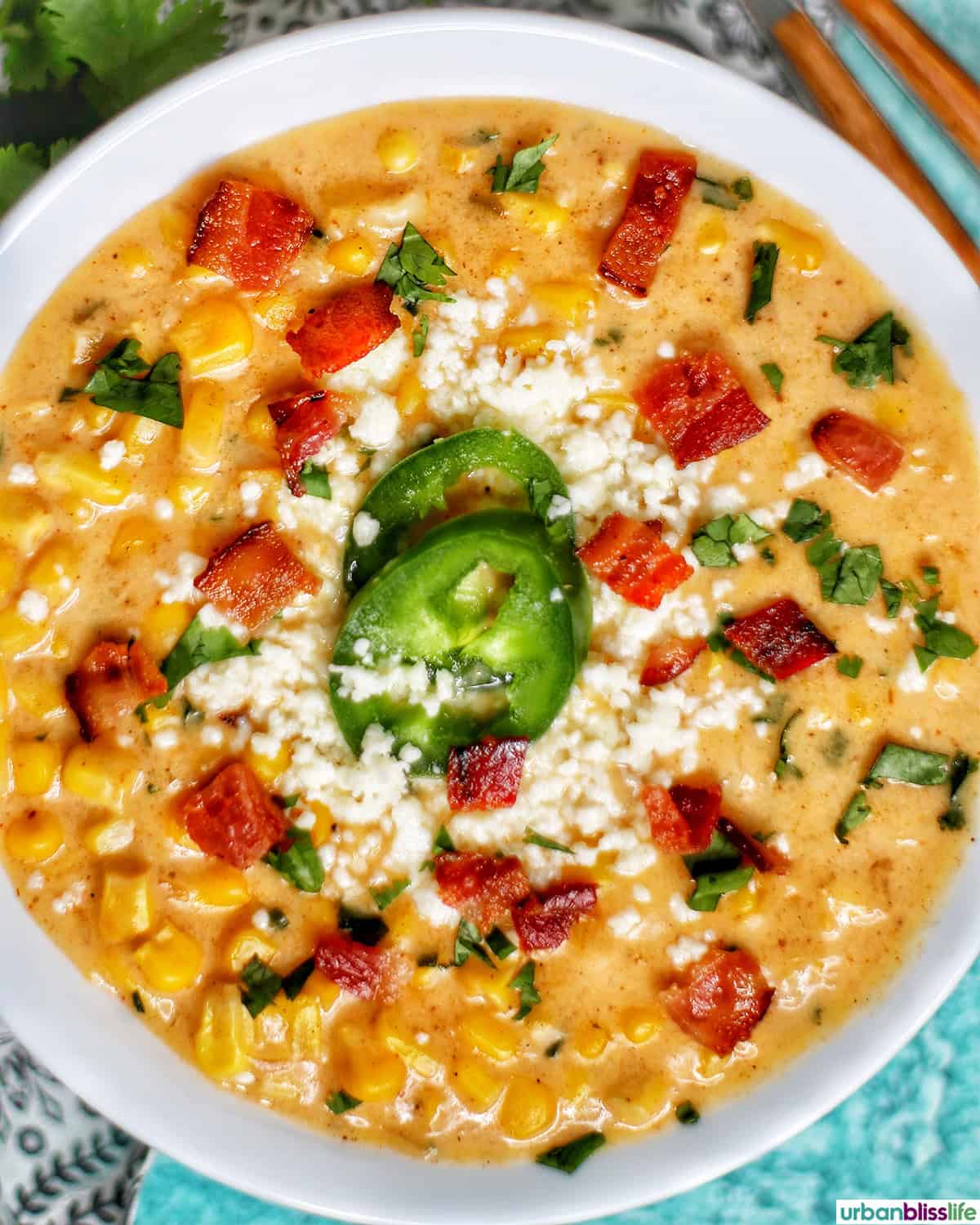 bowl of Instant Pot Mexican Street Corn Chowder with bacon, jalapenos, and Cotija cheese.
