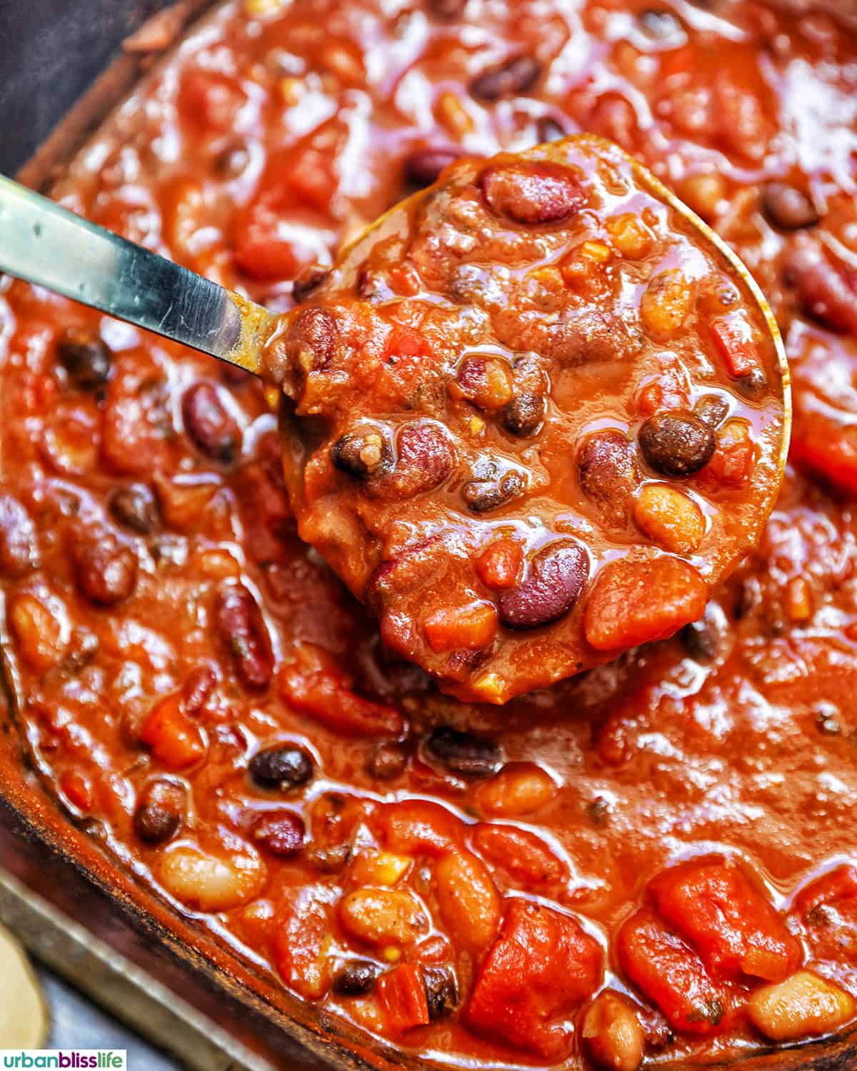 pot of three bean chili with ladle in it.