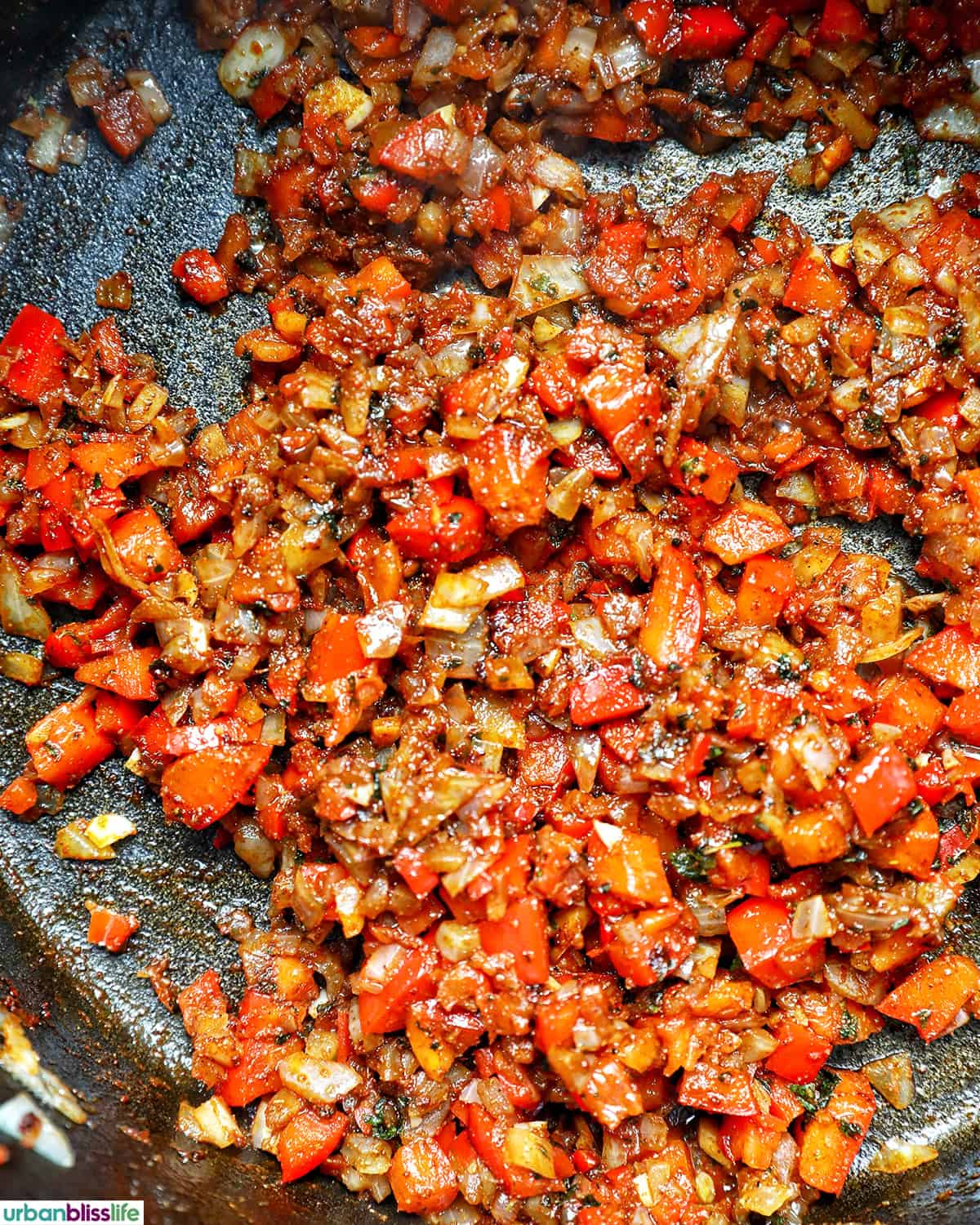veggies and spices in a pot to make vegan three bean chili