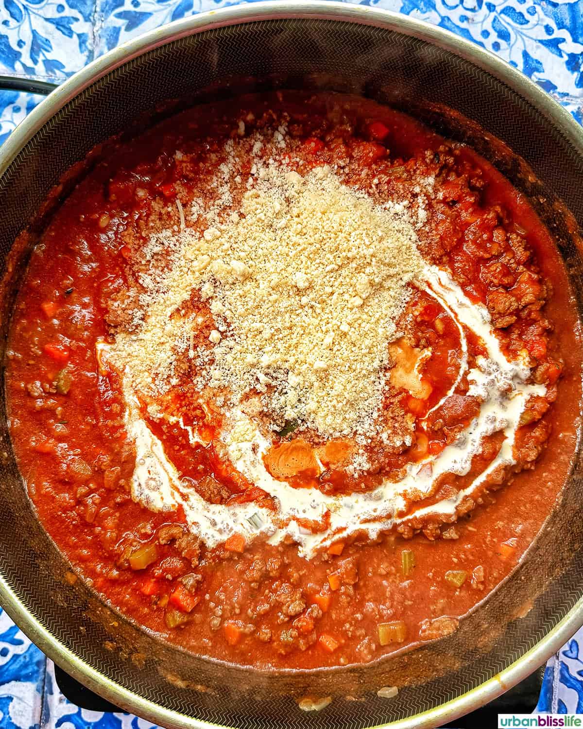 dairy-free cheese added to sauce to make baked pasta bolognese.