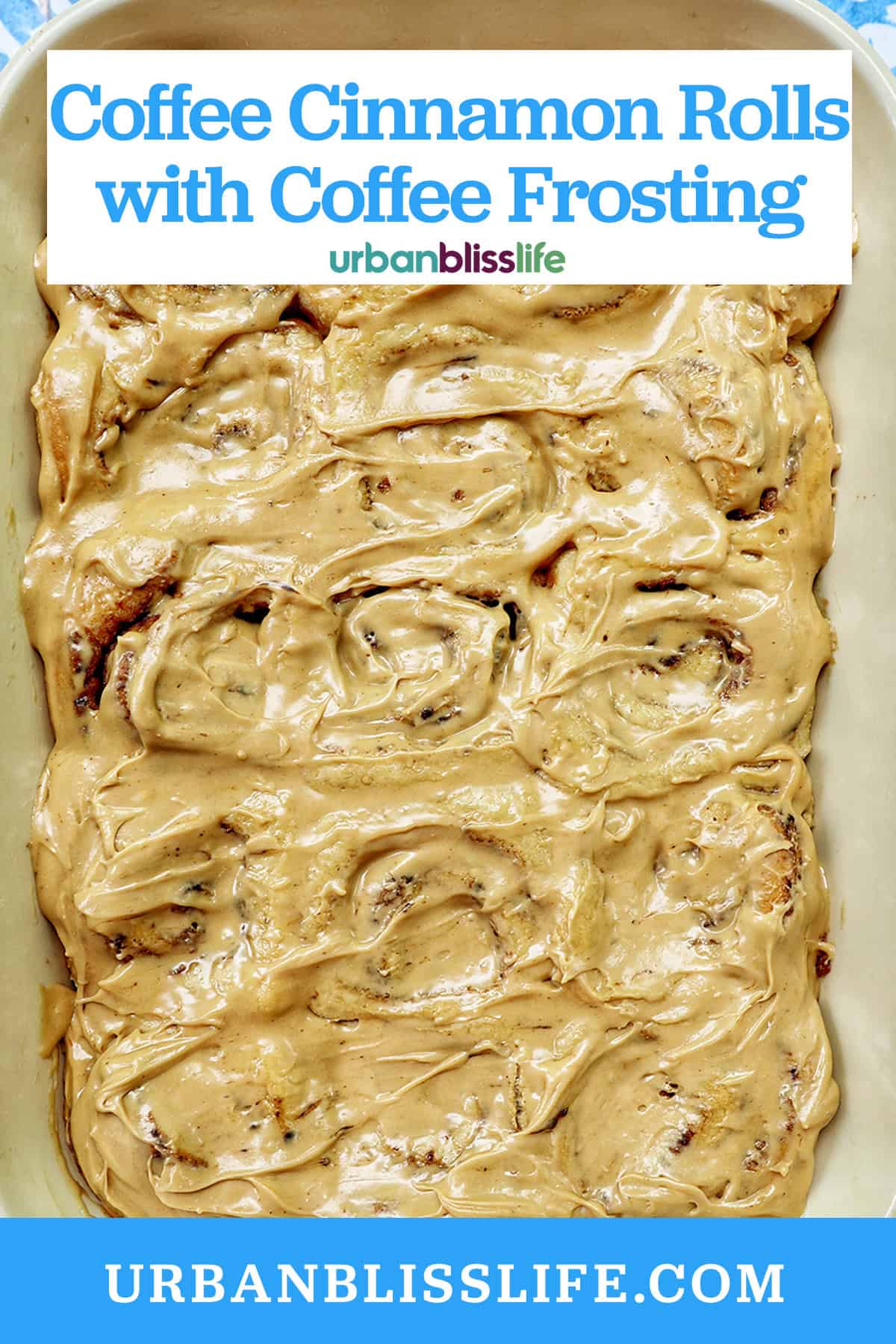 baking dish with coffee cinnamon rolls against a blue and white French backdrop.