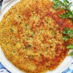 swiss rosti on a plate with parsley garnish.