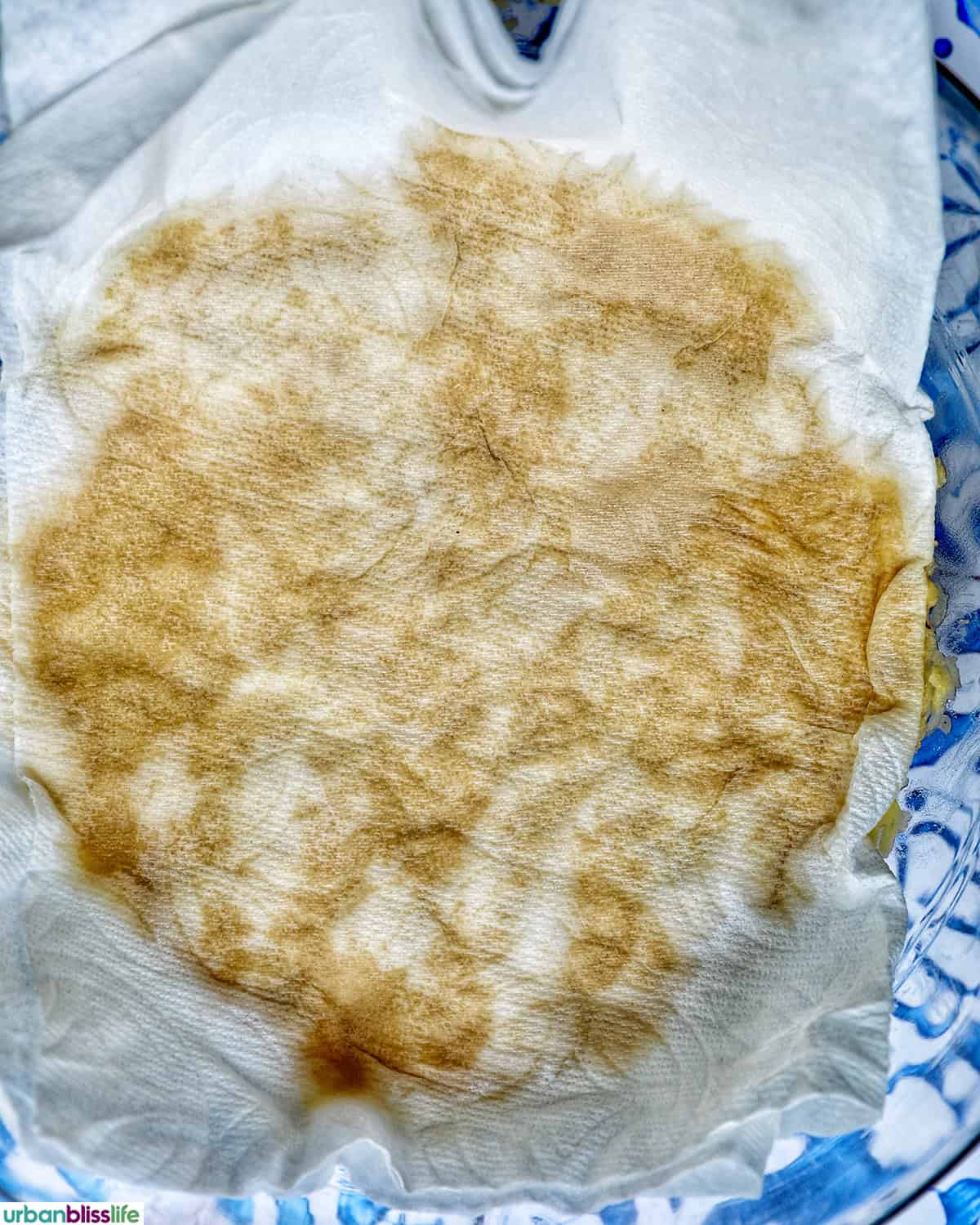 paper towel soaking up liquid from potatoes to make Swiss rosti.
