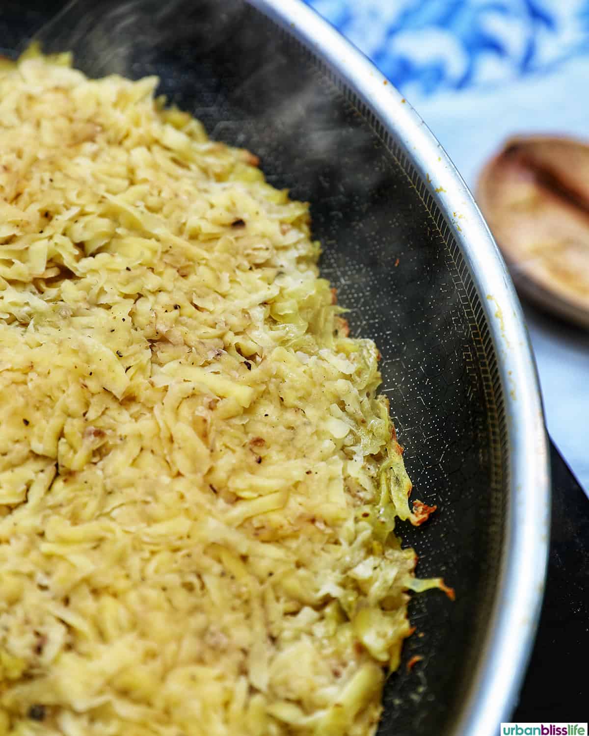 grated potatoes in a pan to make Swiss rosti.