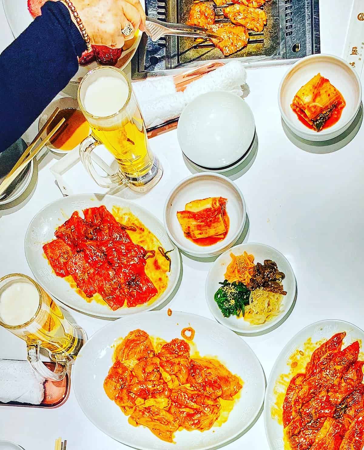 various foods on a table with beer