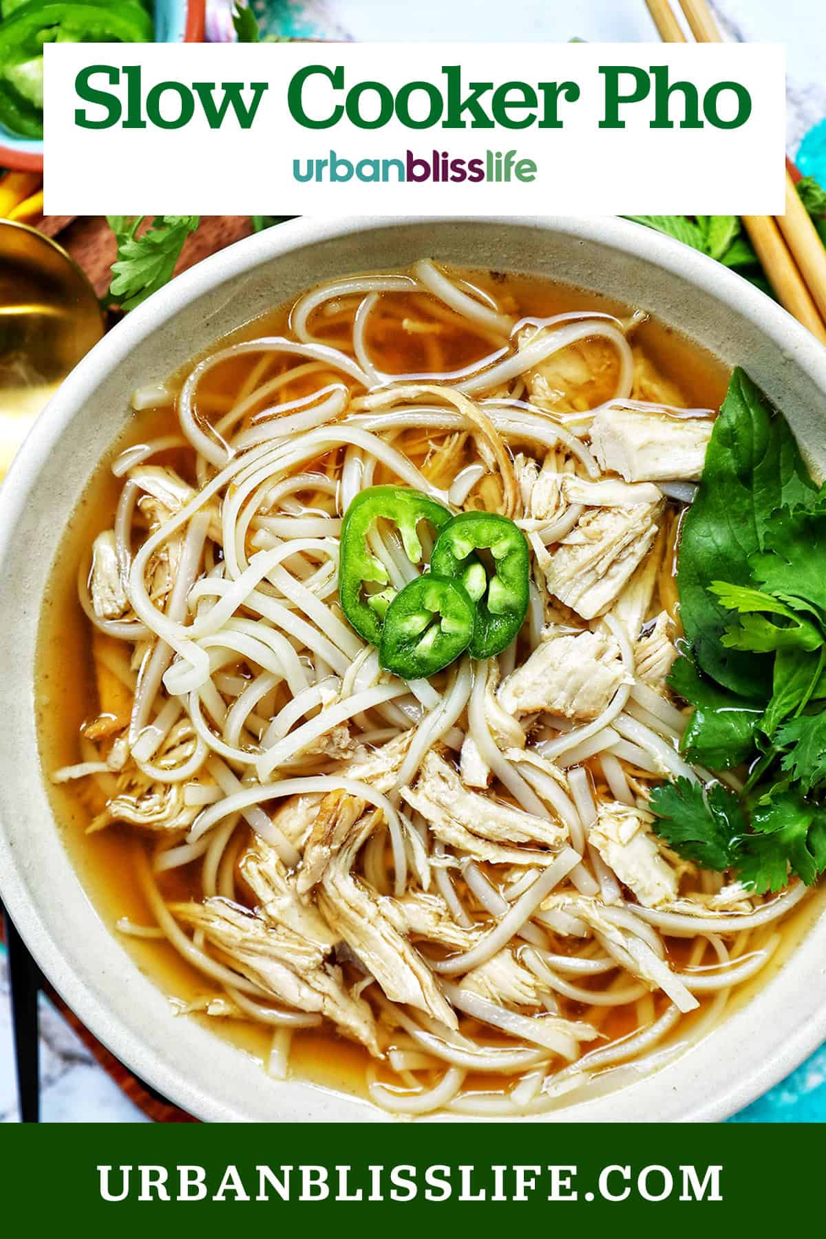bowl of slow cooker chicken pho soup with herbs and chopsticks and title text overlay.