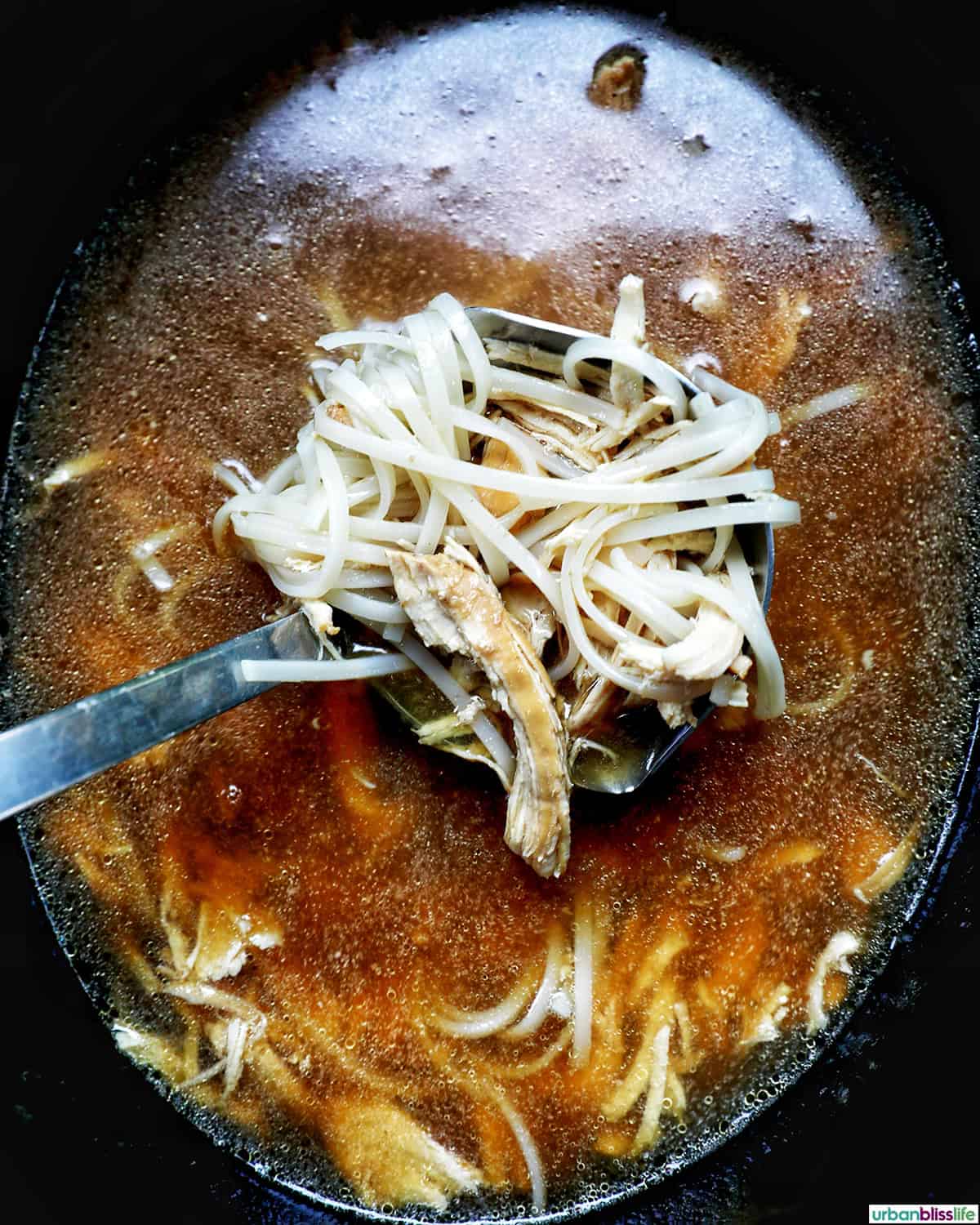 shredded chicken added back to slow cooker soup.