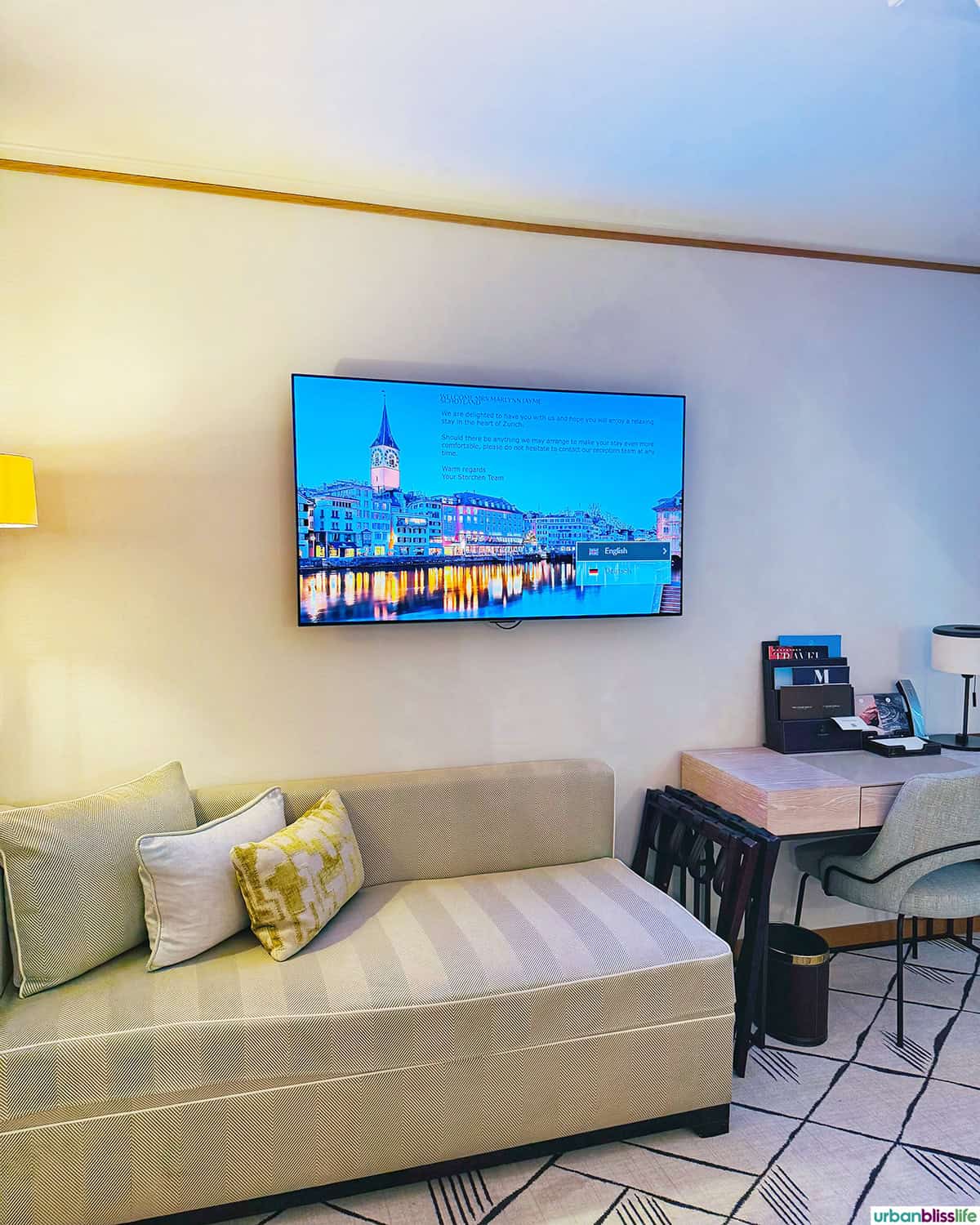 TV and bench in a room at Hotel Storchen Zurich.