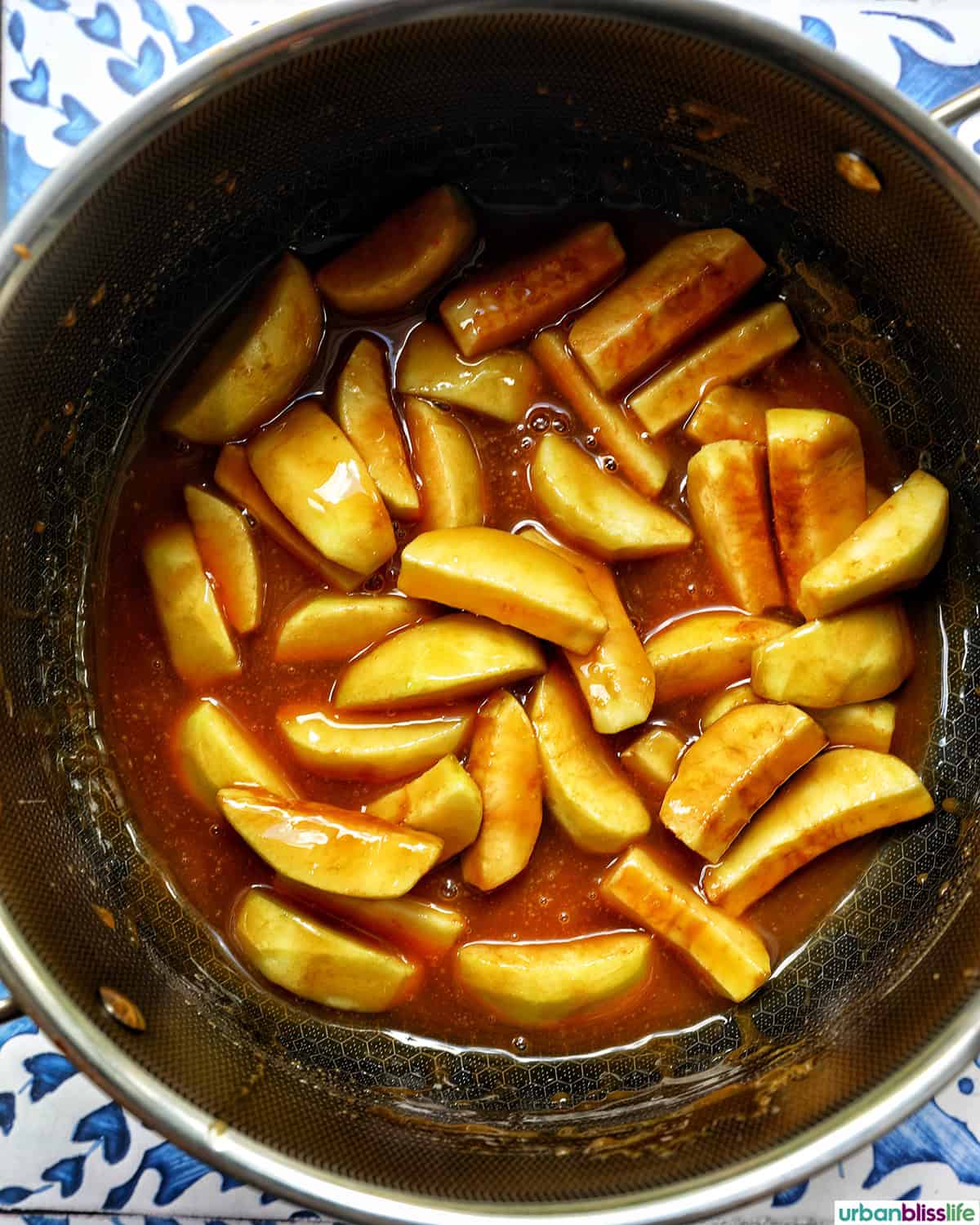 apple slices in caramel in a pot.