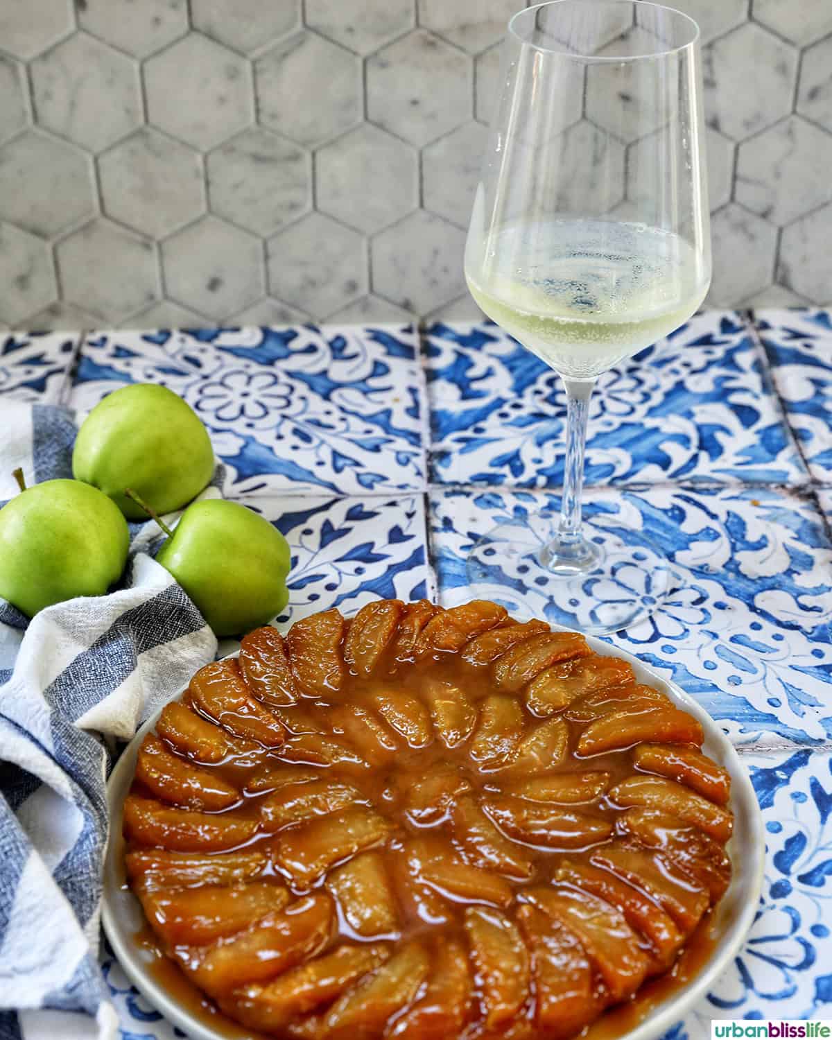 pomme tarte tatin with a glass of white wine.