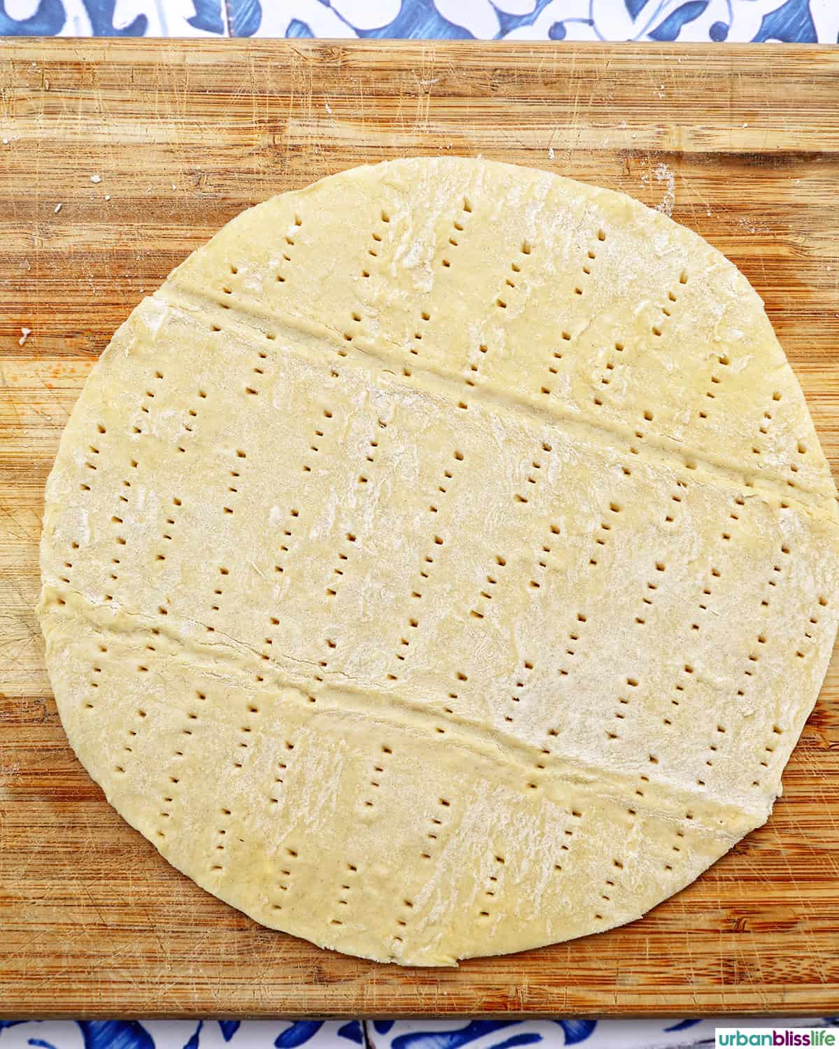 puff pastry cut into a round with holes poked through.