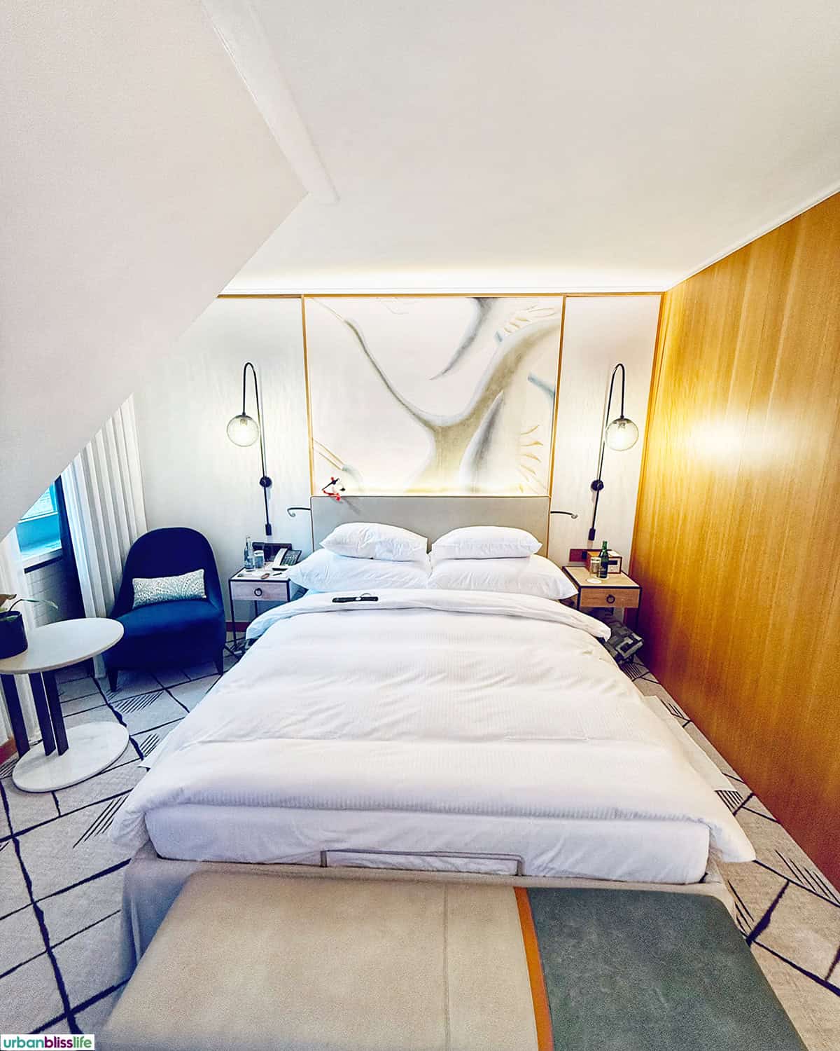 bed and window seat in a room at Hotel Storchen Zürich, Swiss 5-star Michelin hotel.