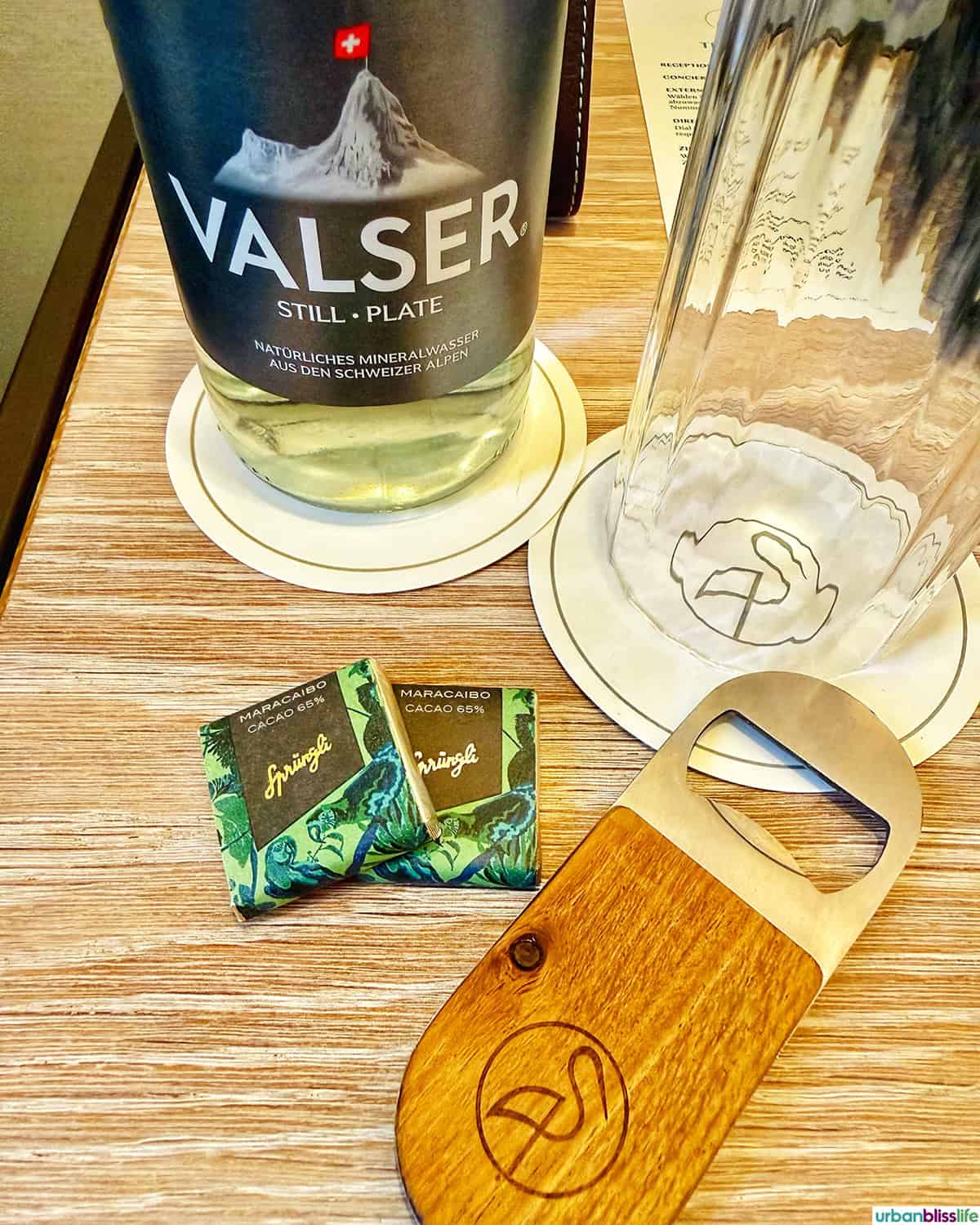 water, chocolates, bottle opener at Hotel Storchen Zürich